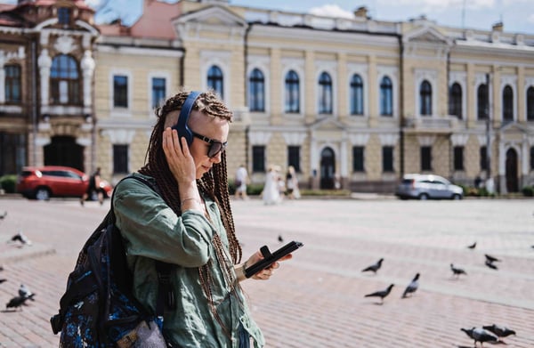 A tourist listening to TTS audio on SmartGuide app